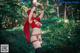 A woman in a red outfit is dancing in the woods.