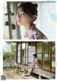 A woman in a kimono sitting on a window sill.