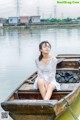 A woman sitting in a boat on the water.