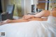 A woman laying on a bed with her legs crossed.