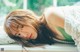 A woman laying on a window sill with her eyes closed.