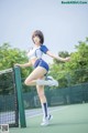 A woman in a blue and white outfit is playing tennis.