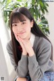 A young woman in a school uniform posing for a picture.