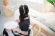 A woman sitting on a chair holding a plate.