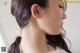 A close up of a woman's face with long dark hair.