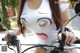 A woman riding a bike with a face painted on it.