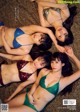 A group of women laying on top of a leopard print blanket.