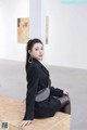 a woman sitting on top of a wooden box