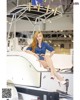 A woman sitting on top of a boat in a showroom.