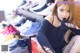 a woman sitting on top of a table next to a bunch of shoes