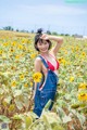 A woman in a sunflower field posing for a picture.