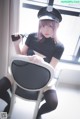 A woman in a police uniform sitting on a chair.