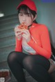 A woman sitting on the stairs eating a slice of pizza.