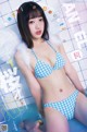 A woman in a blue and white checkered bikini with angel wings.