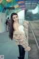 A woman in a fur coat posing for a picture.