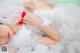 A woman laying on top of a bed covered in cotton candy.