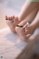 A close up of a person's feet on a table.