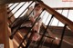 A woman in a school uniform is sitting on the stairs.