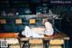 A woman laying on top of a wooden table.