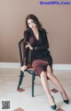 A woman sitting on a chair in a room.