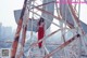 A woman standing on top of a metal structure.