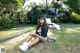 A woman sitting on a chair in the grass.