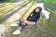 A woman sitting on a chair in the grass.