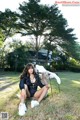 A woman sitting on a chair in the grass.